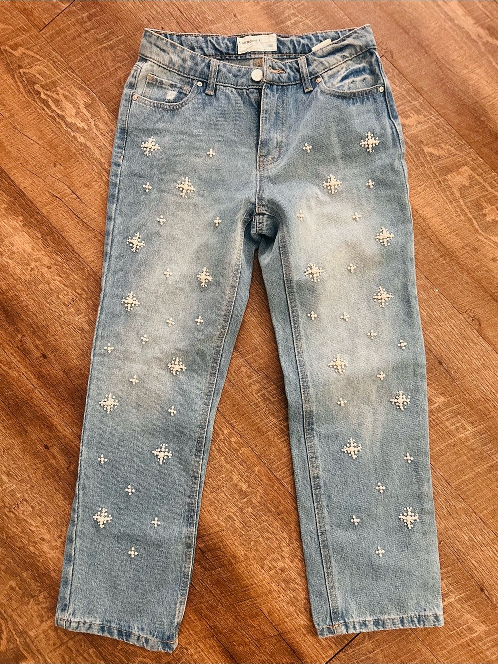 Banjara pearl drop jeans feature a light wash denim with starburst pearls